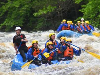 Group of people rafting down rapids