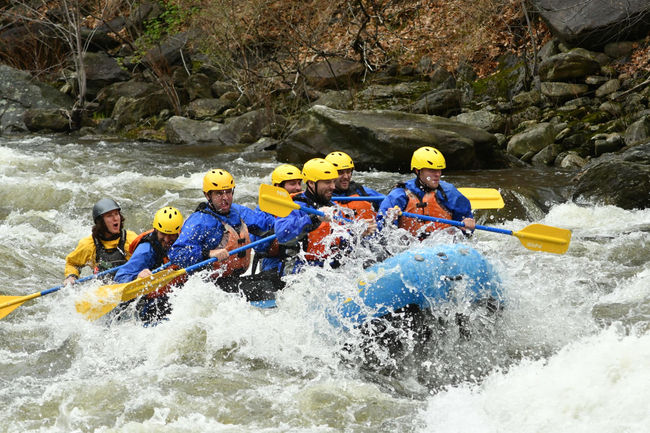 Group of rafters splashing through a section of whitewater on a Zoar trip