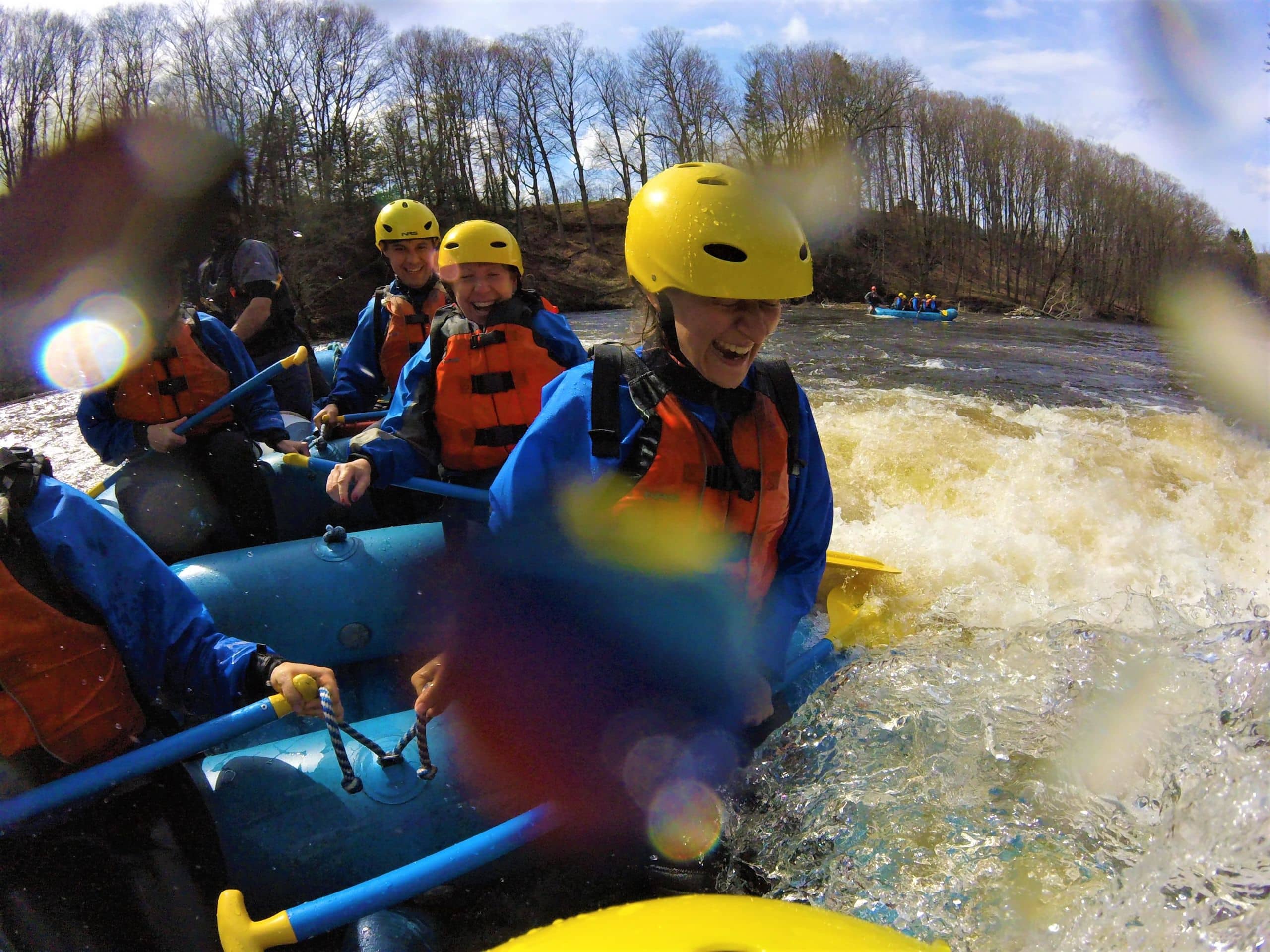 Go pro close-up of a group of rafters headed through a section of whitewater on a rafting trip