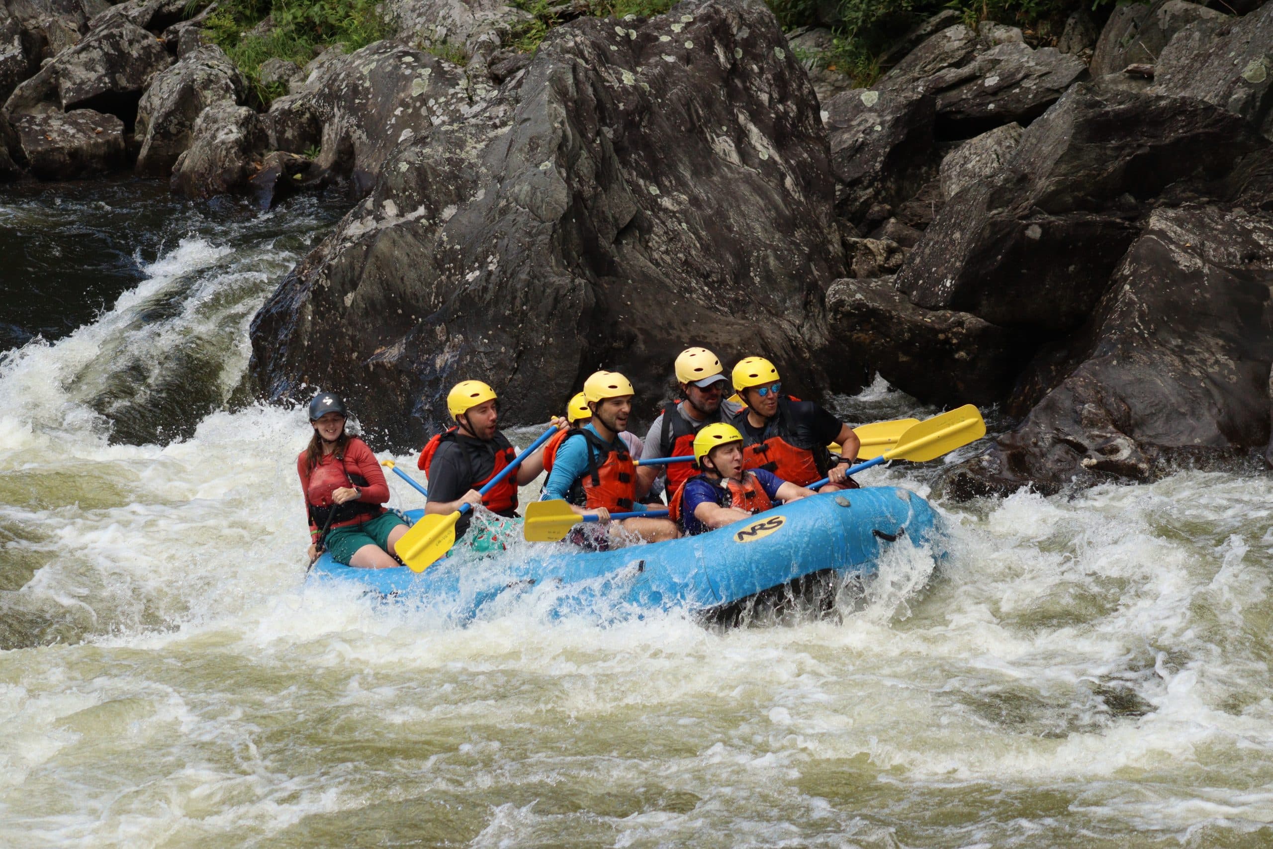 Group of rafters heading through a section of whitewater on a zoar rafting trip