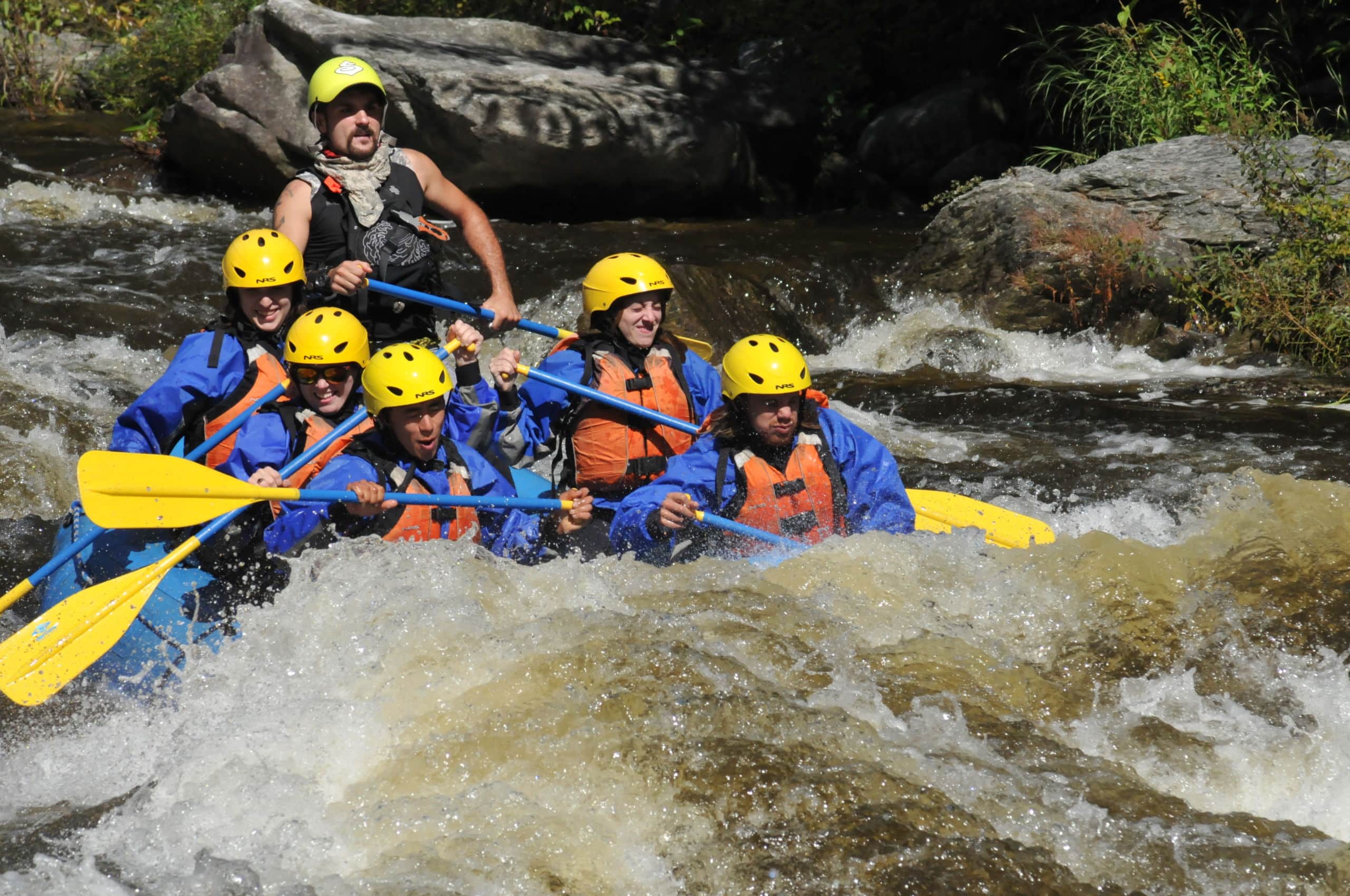 Group of rafters and guide headed through a section of whitewater on the Zoar Gap