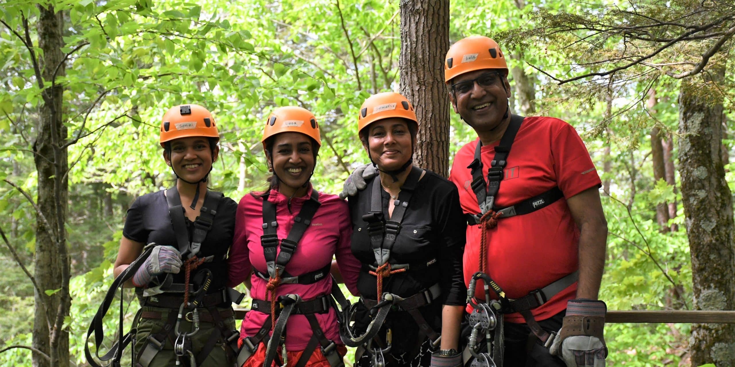 Smiling family standing together on a platform at Zoar's Canopy tour