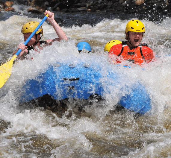 Group in a raft getting splashed by the rapids