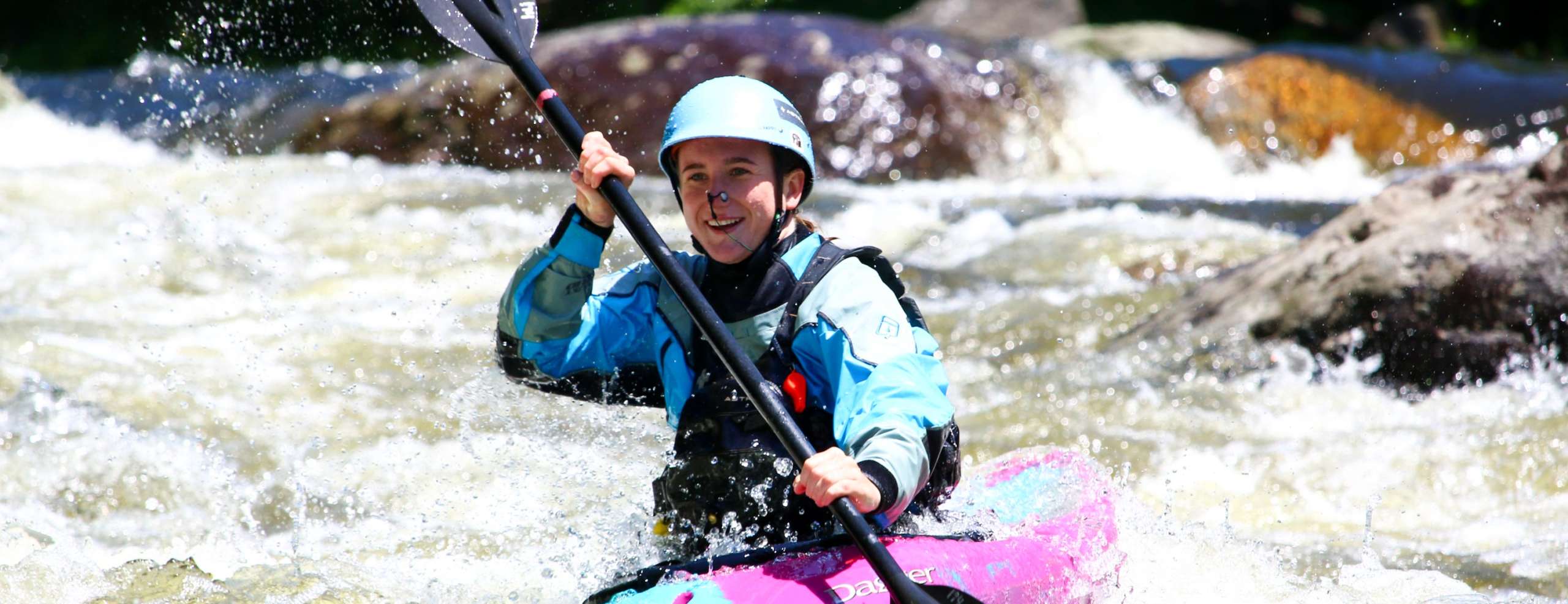 Woman kayaking rapids