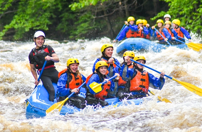 Group rafting down the Miller River on the adventure package trip