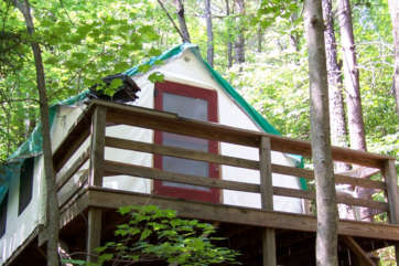 Close up of a cabin with a porch