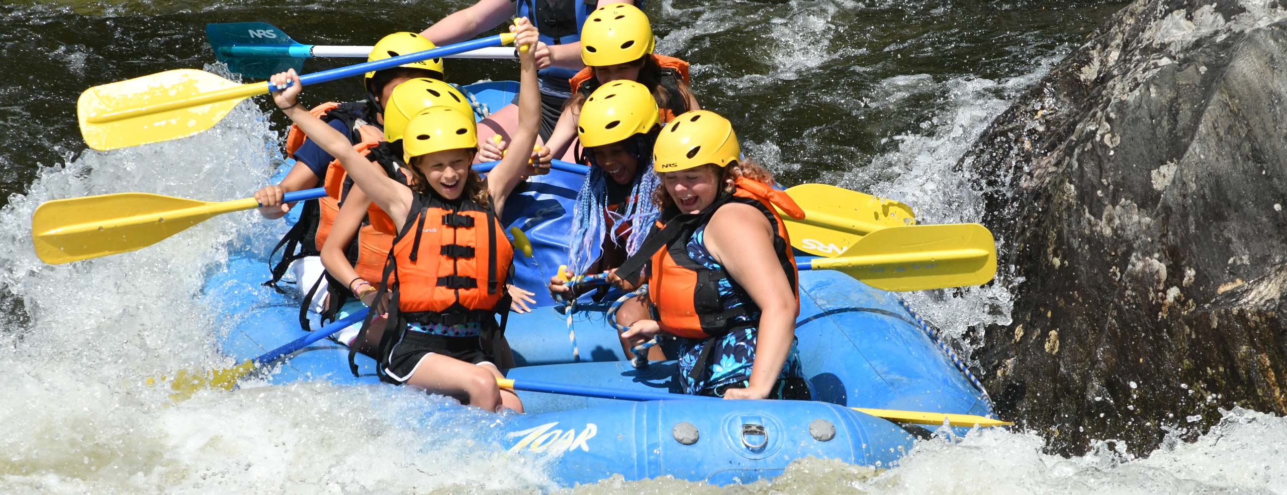 Group of girls excitedly rafting down the zoar gap