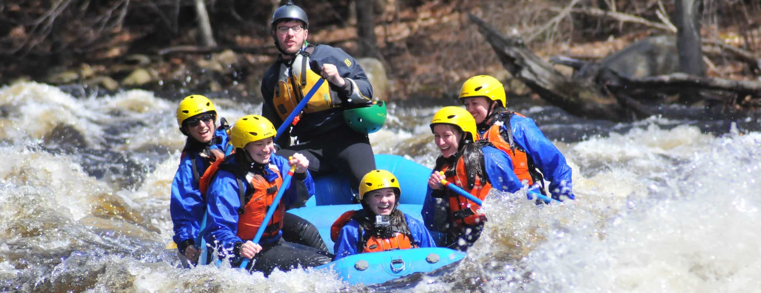 Group of young people rafting down Millers River