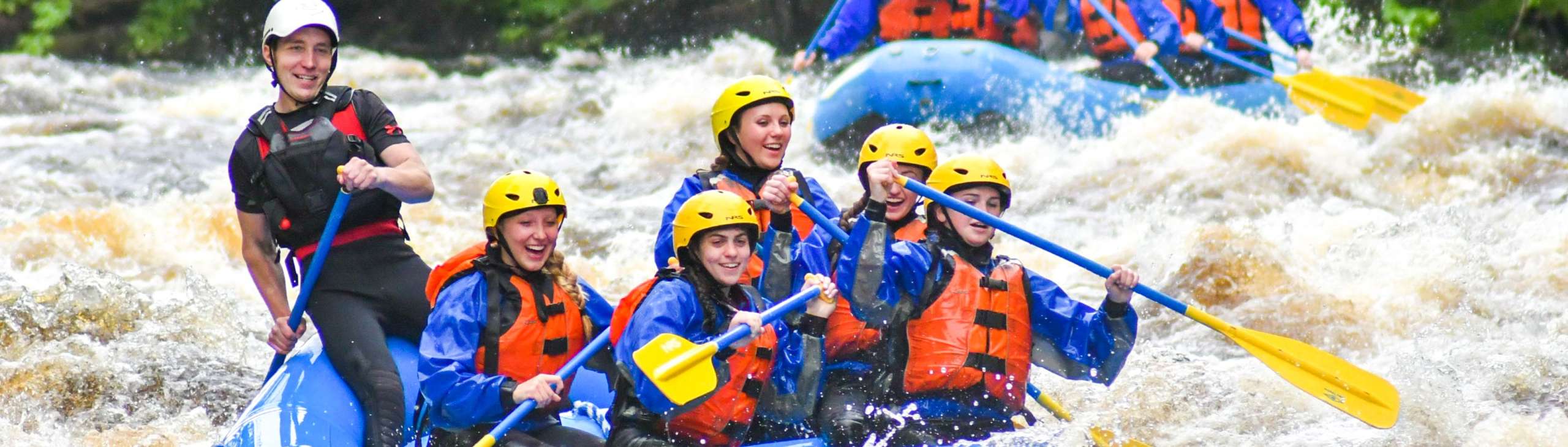 Group rafting down the Miller River on the adventure package trip