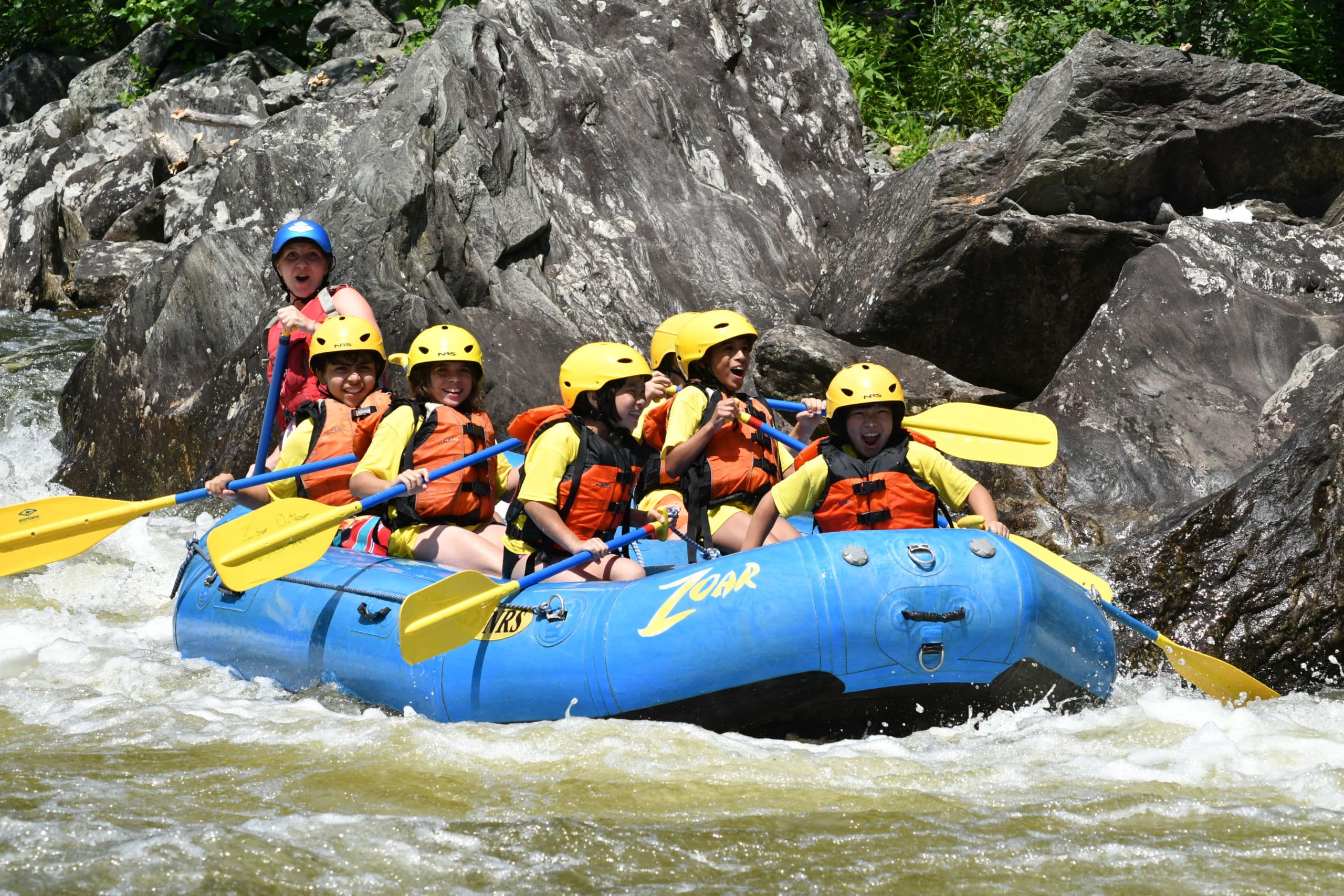 Guide with a group of young rafters headed through the Zoar Gap rapids