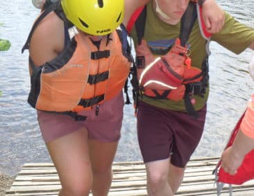 Zoar rafters in life-jackets walking up the dock together