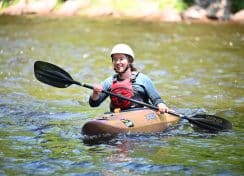 woman learning to whitewater kayak