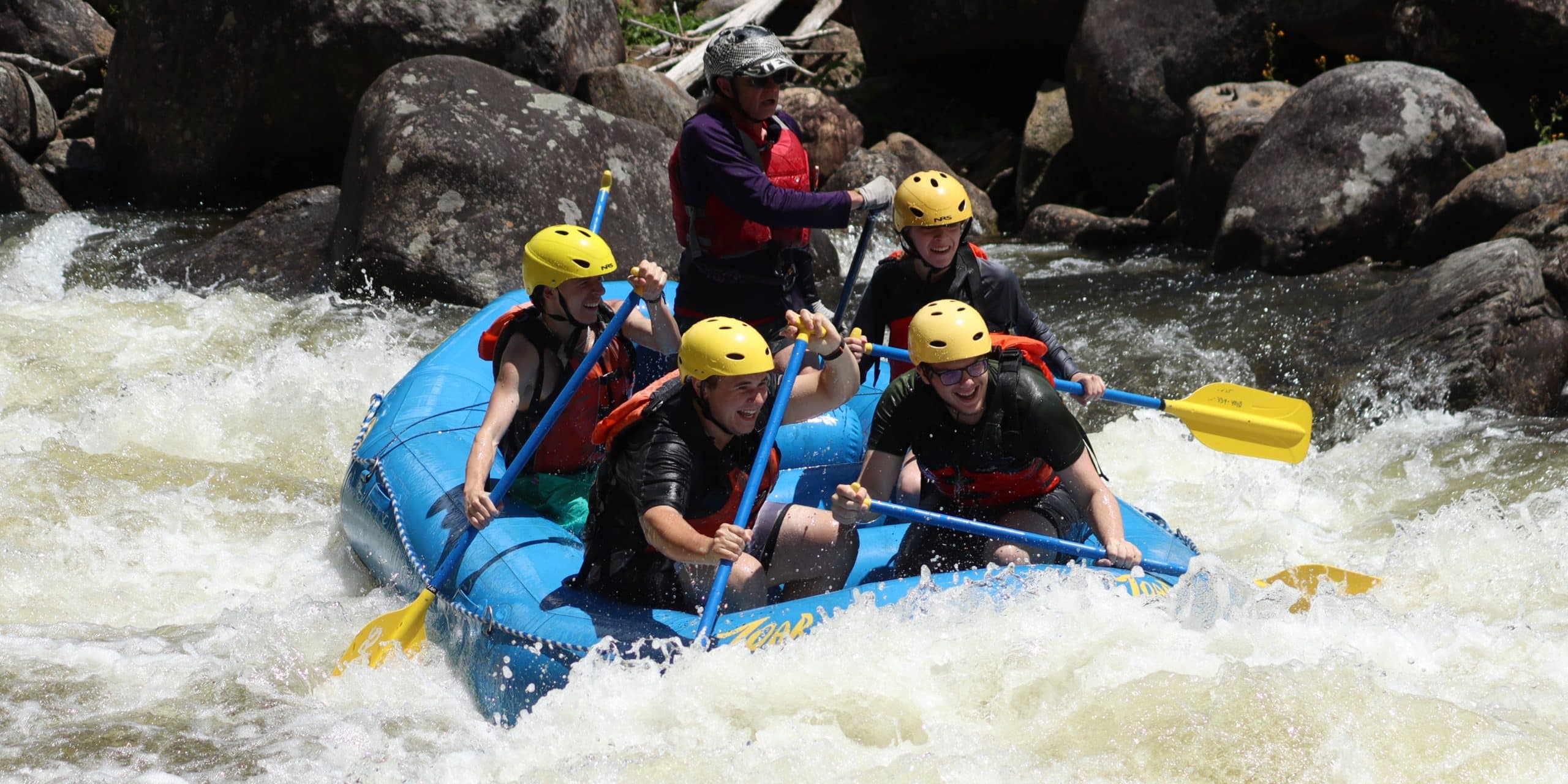 church group rafting on the river through rapids